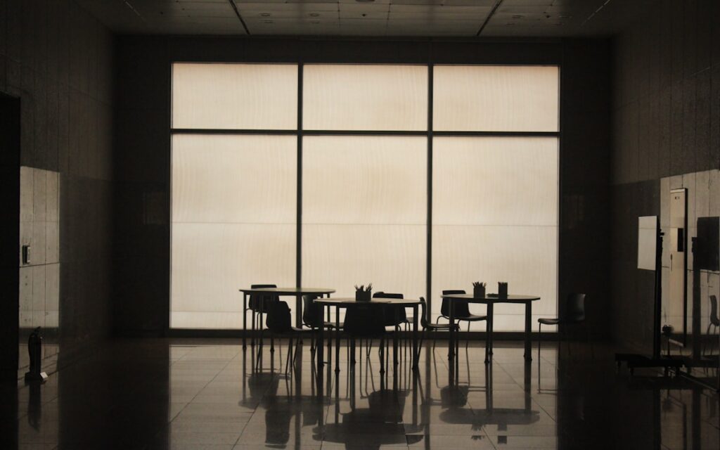 Confident Professional Stepping Into Light Window Office